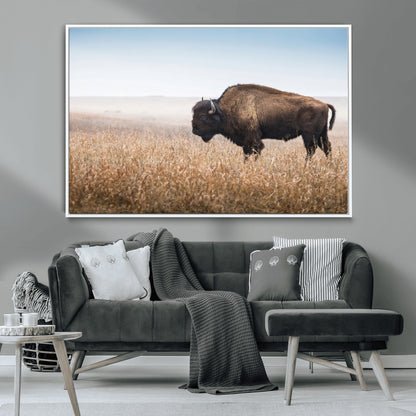 A majestic bison standing in an open prairie field, its strong form blending into the golden grass under a vast blue sky, evoking the wild spirit of the American plains.