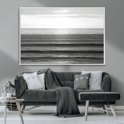 Minimalist black and white ocean view with layered waves reflecting sunlight, evoking a sense of calm and coastal serenity.