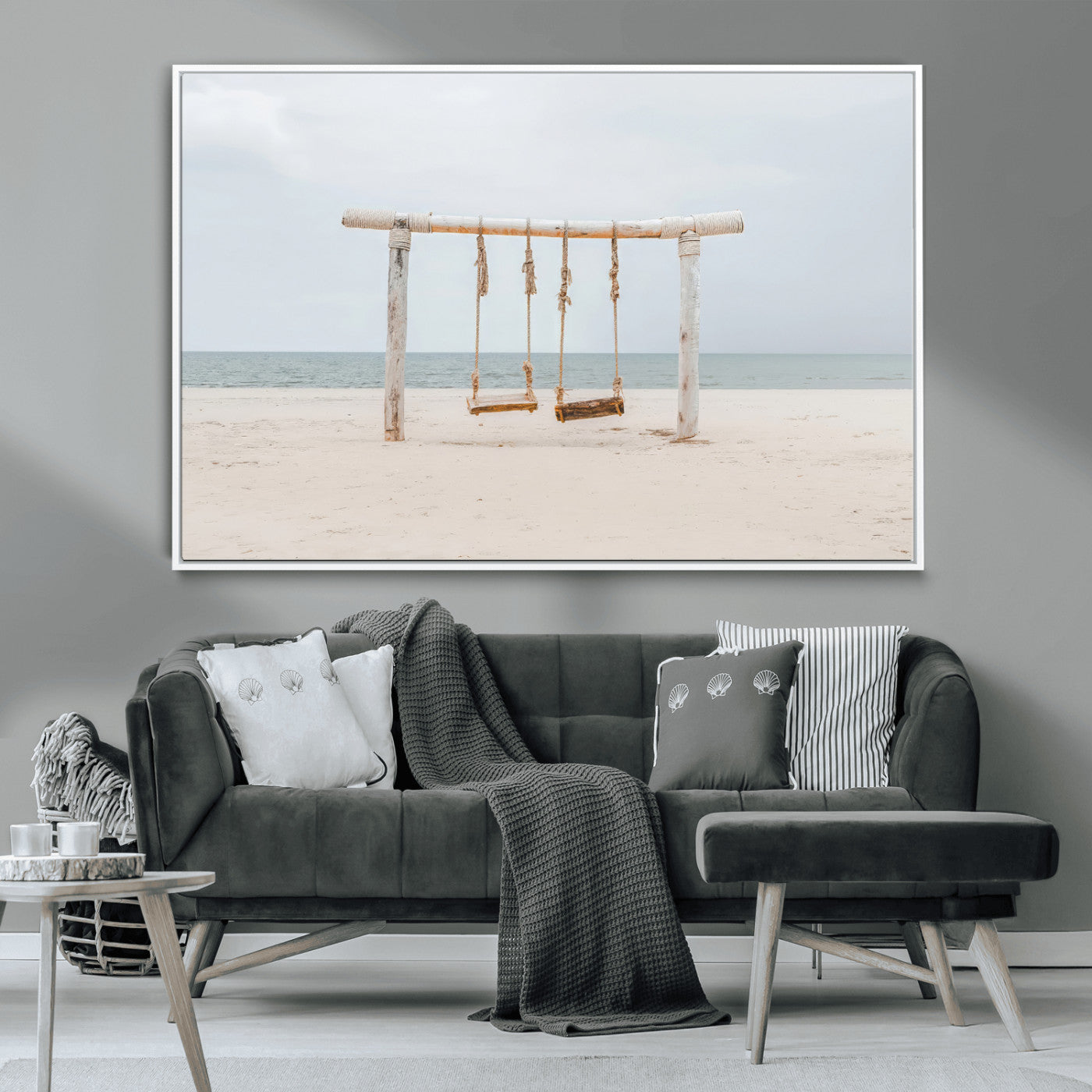 A rustic wooden beach swing stands on a serene sandy shore with an ocean horizon in the background, creating a tranquil and dreamy coastal escape.