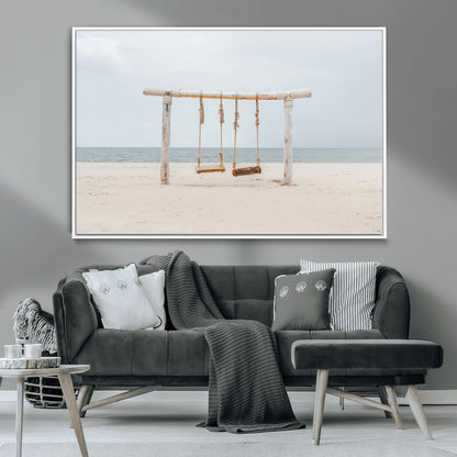 A rustic wooden beach swing stands on a serene sandy shore with an ocean horizon in the background, creating a tranquil and dreamy coastal escape.
