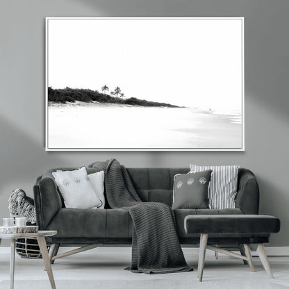 A black and white minimalist coastal scene with a vast open beach, distant palm trees, and a lone figure walking along the shoreline, evoking serenity and solitude.