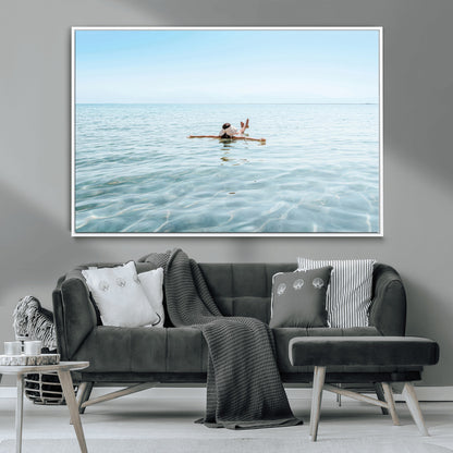 A peaceful minimalist scene of a person floating on crystal-clear water, surrounded by a vast open horizon, capturing relaxation and serenity in a tranquil aquatic setting.