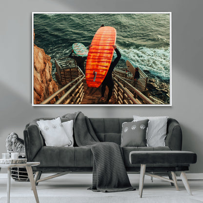 A surfer carrying a bold orange surfboard down a rugged staircase toward the ocean, bathed in golden hour light, capturing the energy of coastal adventure.
