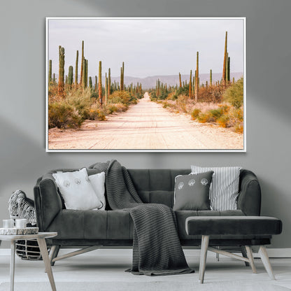 A desert road lined with saguaro cacti under a golden sky, creating a warm southwestern feel, perfect for boho or rustic decor.