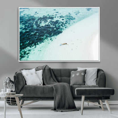 Canvas featuring an aerial view of a swimmer in shallow turquoise waters with coral patterns, ideal for tropical coastal home decor.