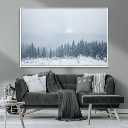 Snow-covered forest under misty sky, soft light breaking through clouds, ideal for minimalist or Nordic-inspired home decor.