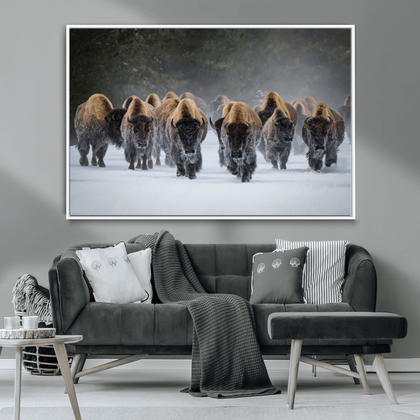 A herd of American bisons walking through deep snow in a forest, evoking a powerful rustic wilderness mood for western-style interiors.