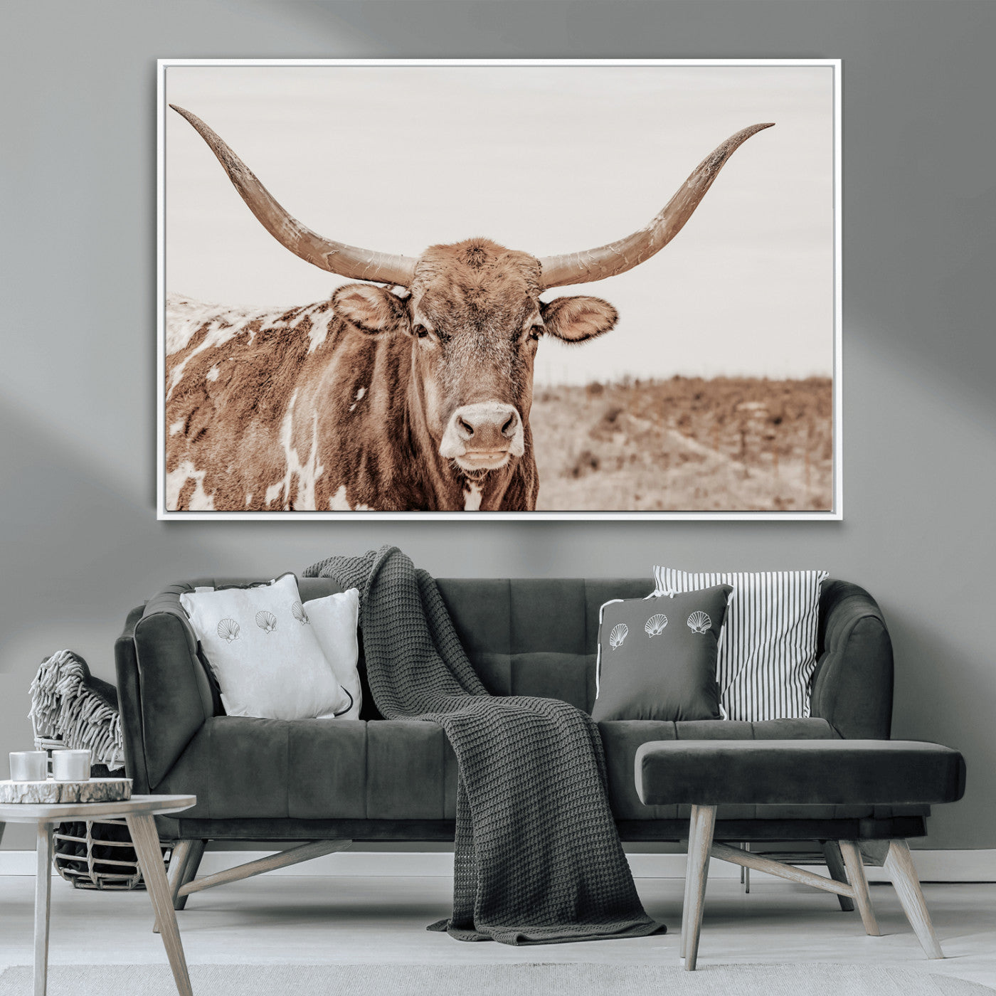 A longhorn cow in soft beige desert tones, standing calmly in open land, perfect for neutral western or rustic farmhouse interiors.