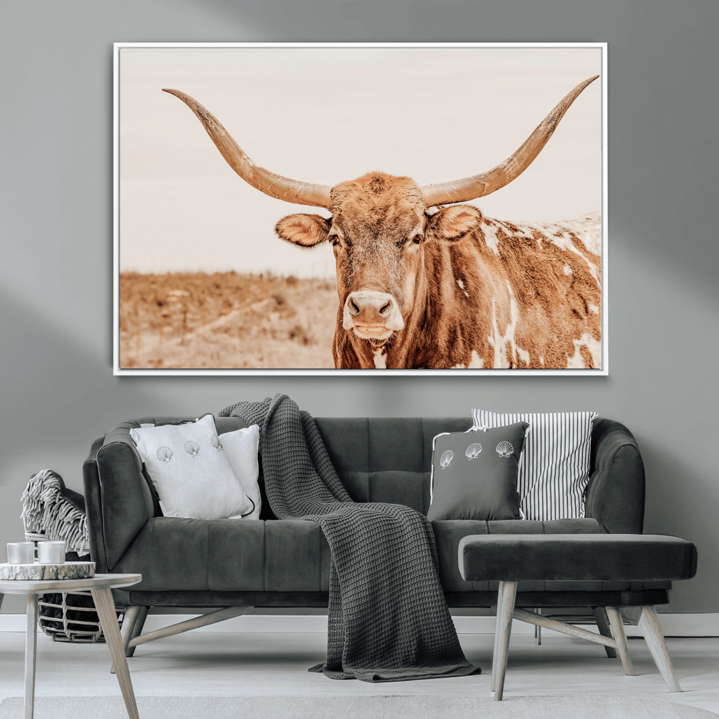 A longhorn bull standing proudly in a sunlit desert field with warm neutral tones, ideal for rustic western or farmhouse interiors.
