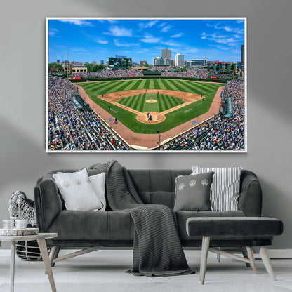 A wide-angle shot of a baseball field filled with spectators, with players on the field and the iconic Wrigley Field scoreboard in the background.