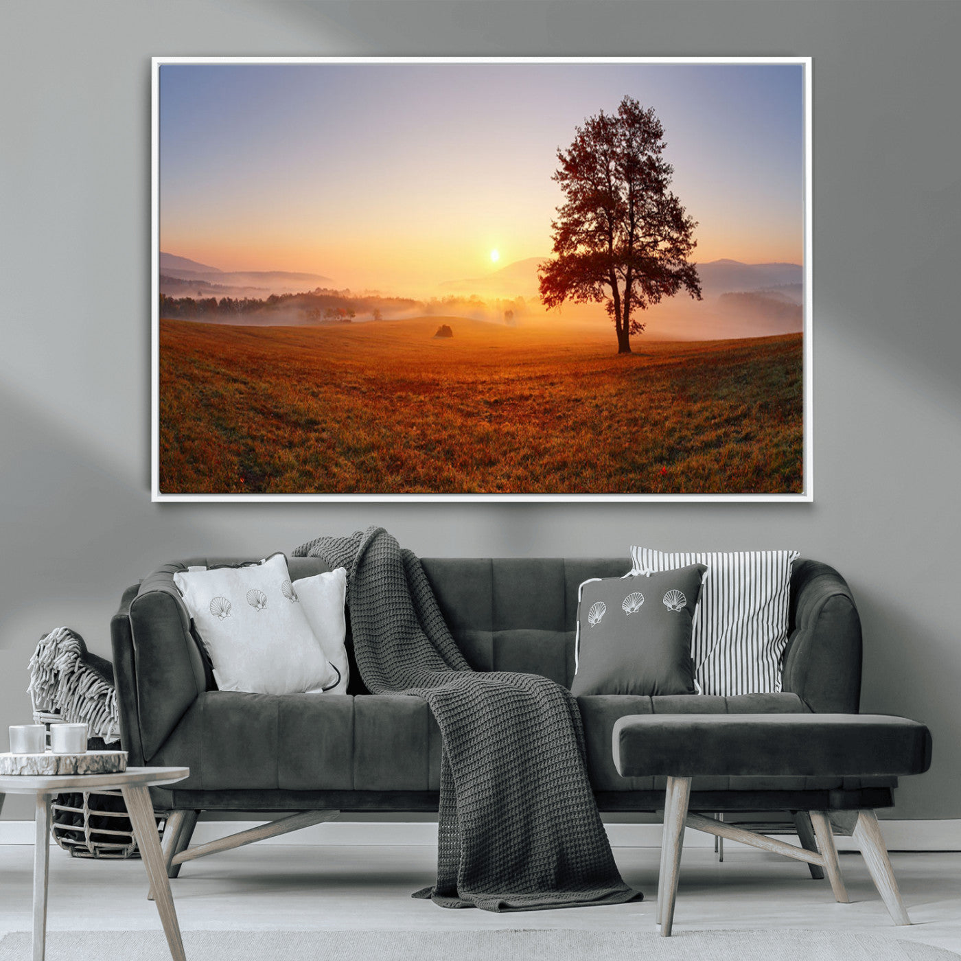 A tranquil landscape at sunrise with a mist-covered field and a lone tree, creating a peaceful and natural atmosphere.