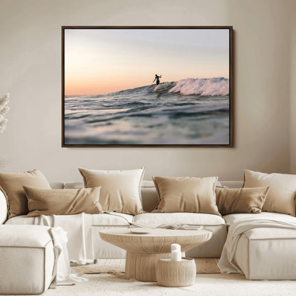 Framed canvas of a female surfer balancing on a wave at sunset, perfect for serene surf or ocean-inspired coastal decor.