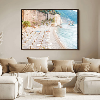 Wall art of a calm Mediterranean beach with rows of sun loungers and umbrellas in soft pastel tones, perfect for light coastal or vacation-themed decor.