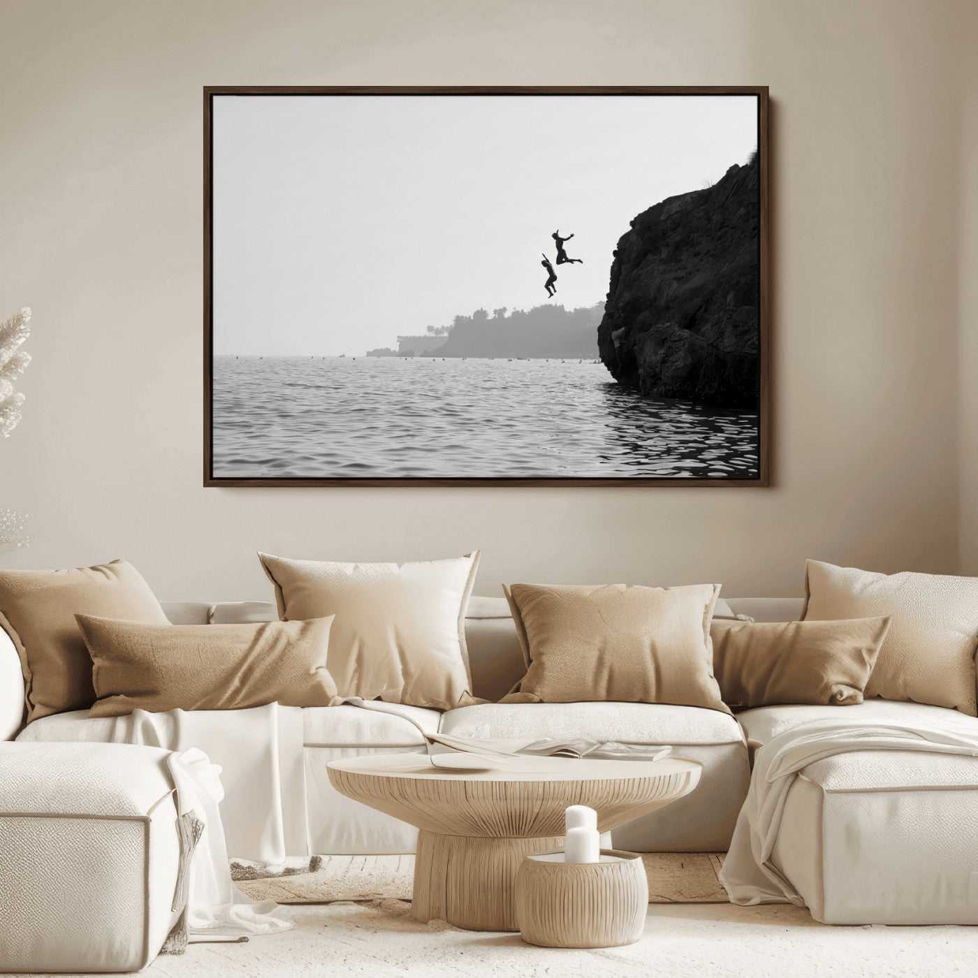 Black and white canvas of two figures cliff jumping into the sea, captured with moody tones, ideal for modern coastal or adventure-themed home decor.   2/2