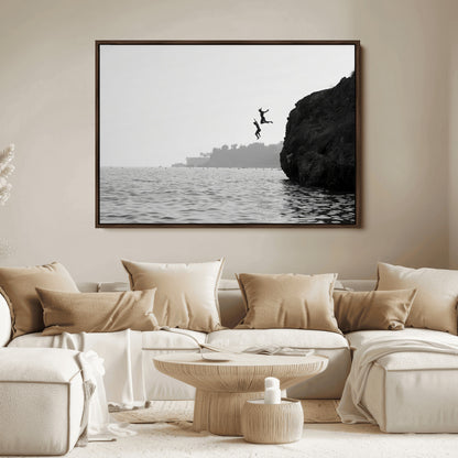 Black and white canvas of two figures cliff jumping into the sea, captured with moody tones, ideal for modern coastal or adventure-themed home decor.   2/2