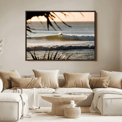 Photo of a surfer riding a golden hour wave at sunset, with tropical tones and dreamy light, perfect for tropical boho or coastal home decor.