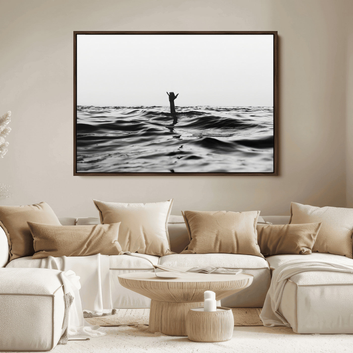 Black and white ocean with a hand making a surfer sign among dark waves, creating a dramatic and minimalist seascape with bold contrast.