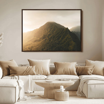 Sunlit mountain peak with mist rolling over its rugged slopes, bathed in golden light, creating a warm and tranquil nature-inspired scene.