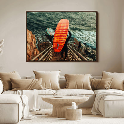 A surfer carrying a bold orange surfboard down a rugged staircase toward the ocean, bathed in golden hour light, capturing the energy of coastal adventure.