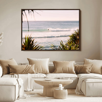 Canvas of a lone surfer riding a pastel wave at sunrise, perfect for tropical or coastal-themed spaces with a relaxed, airy vibe.