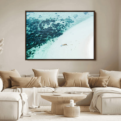 Canvas featuring an aerial view of a swimmer in shallow turquoise waters with coral patterns, ideal for tropical coastal home decor.