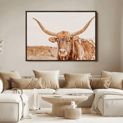 A longhorn bull standing proudly in a sunlit desert field with warm neutral tones, ideal for rustic western or farmhouse interiors.