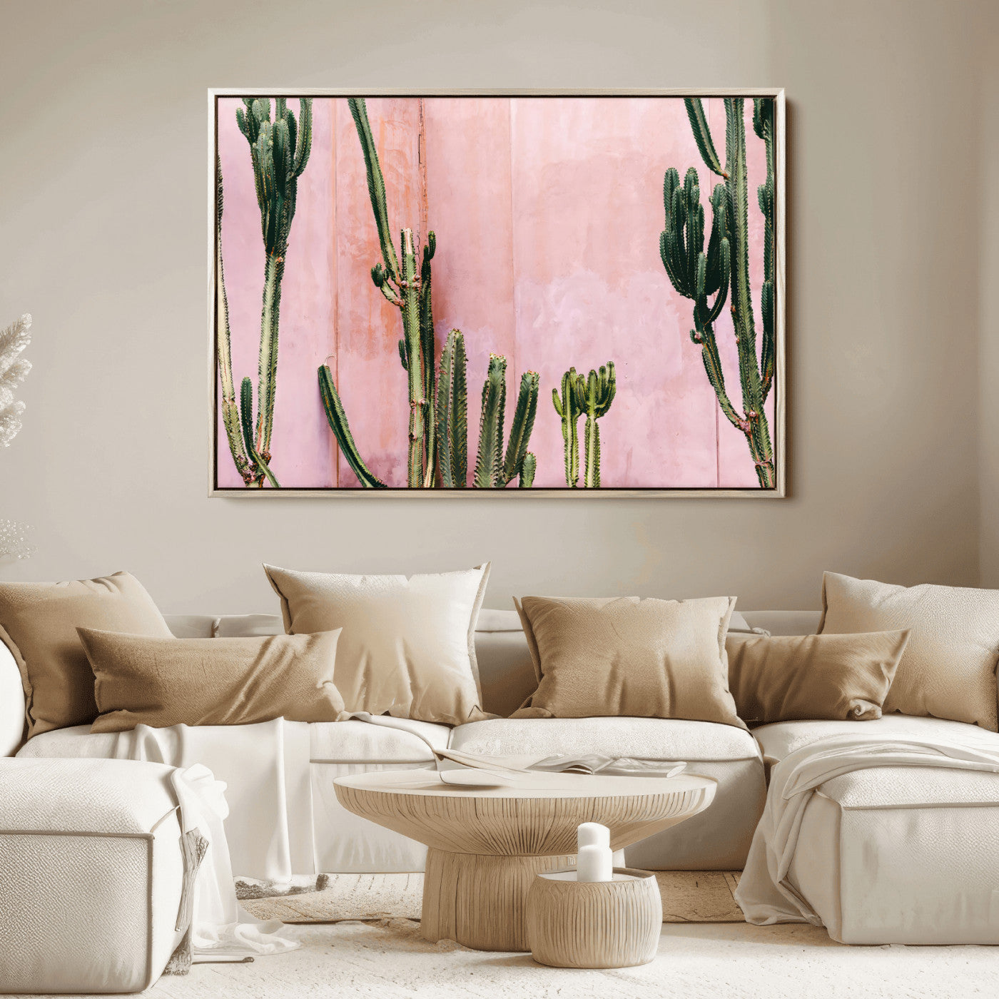 Framed canvas of tall green cacti against a soft pink wall, ideal for modern desert or colorful southwest-inspired home decor.
