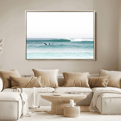 Minimalist photo of a lone surfer on calm aqua waves under bright sky, perfect for Scandinavian coastal or serene ocean-inspired home decor.