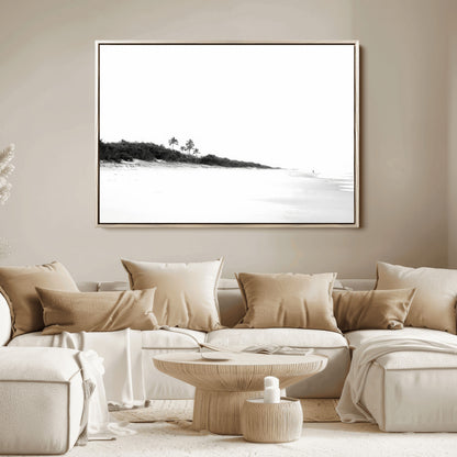 A black and white minimalist coastal scene with a vast open beach, distant palm trees, and a lone figure walking along the shoreline, evoking serenity and solitude.
