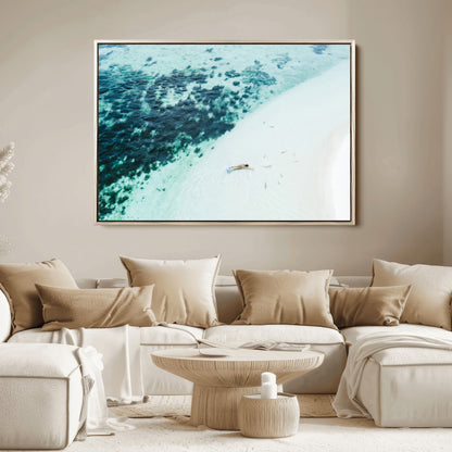 Canvas featuring an aerial view of a swimmer in shallow turquoise waters with coral patterns, ideal for tropical coastal home decor.