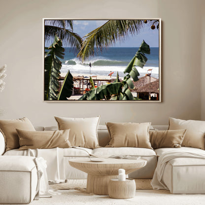 Canvas wall art of a tropical surf scene framed by palm trees, with a surfer on the shore and waves rolling in, ideal for beach-themed decor.
