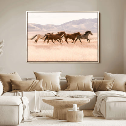 A herd of wild horses galloping through a sunlit desert plain with mountains in the background, perfect for rustic or western-themed wall decor.