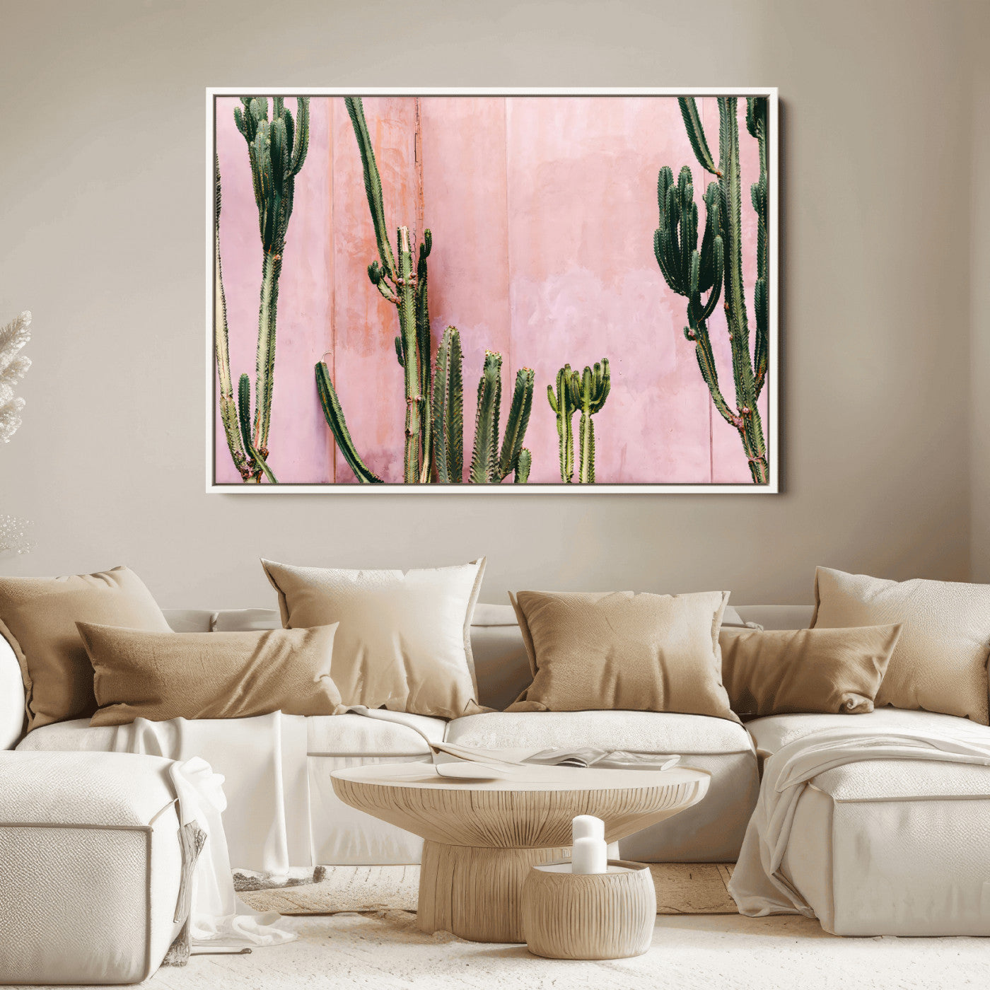 Framed canvas of tall green cacti against a soft pink wall, ideal for modern desert or colorful southwest-inspired home decor.