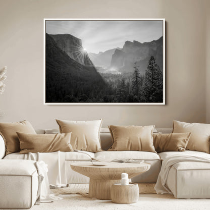 Black and white landscape of Yosemite with sun rays peeking over El Capitan, ideal for moody nature or modern rustic decor.