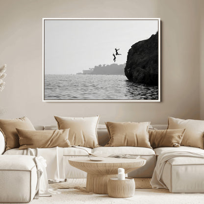 Black and white canvas of two figures cliff jumping into the sea, captured with moody tones, ideal for modern coastal or adventure-themed home decor.   2/2