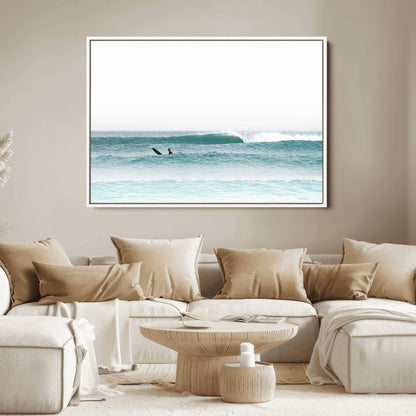 Minimalist photo of a lone surfer on calm aqua waves under bright sky, perfect for Scandinavian coastal or serene ocean-inspired home decor.
