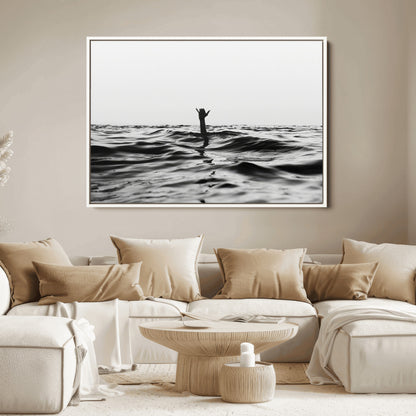 Black and white ocean with a hand making a surfer sign among dark waves, creating a dramatic and minimalist seascape with bold contrast.