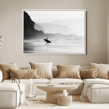 A lone surfer walking along a misty beach with cliffs in the background, carrying their board, capturing a serene and minimal ocean moment.