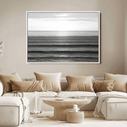 Minimalist black and white ocean view with layered waves reflecting sunlight, evoking a sense of calm and coastal serenity.