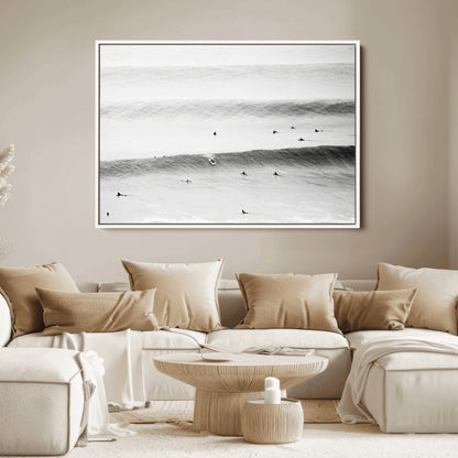 A monochrome photograph of swimmers gliding through gentle ocean waves, evoking a sense of calm and movement.