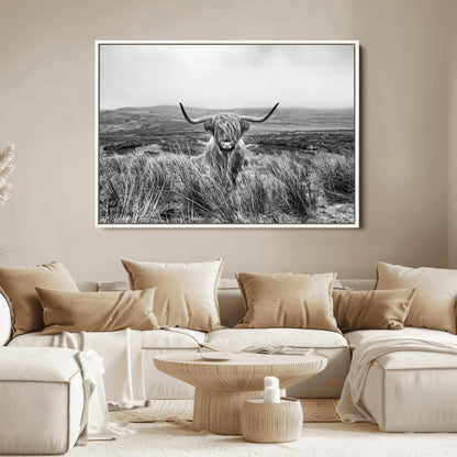 A black and white portrait of a Highland cow in a foggy Scottish countryside, capturing a rustic aesthetic and tranquil farm escape.
