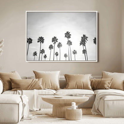 A black and white minimalist scene featuring tall palm trees silhouetted against a bright sky, creating a dreamy and timeless tropical aesthetic.