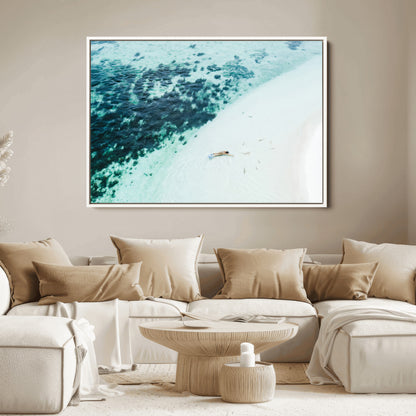 Canvas featuring an aerial view of a swimmer in shallow turquoise waters with coral patterns, ideal for tropical coastal home decor.