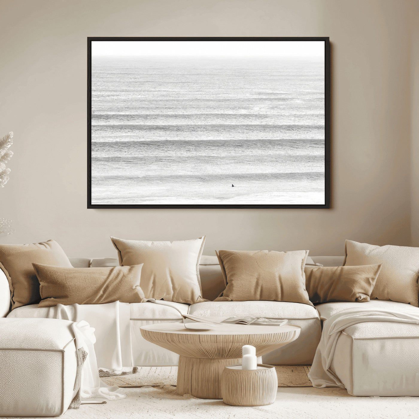 Monochrome photo of a lone surfer in calm layered waves, perfect for minimalist coastal or moody ocean-inspired wall decoration.