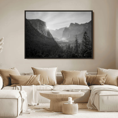 Black and white landscape of Yosemite with sun rays peeking over El Capitan, ideal for moody nature or modern rustic decor.