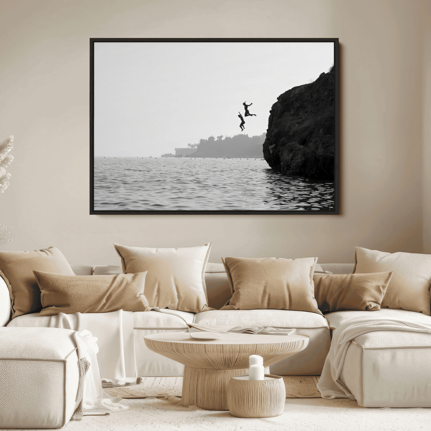 Black and white canvas of two figures cliff jumping into the sea, captured with moody tones, ideal for modern coastal or adventure-themed home decor.   2/2