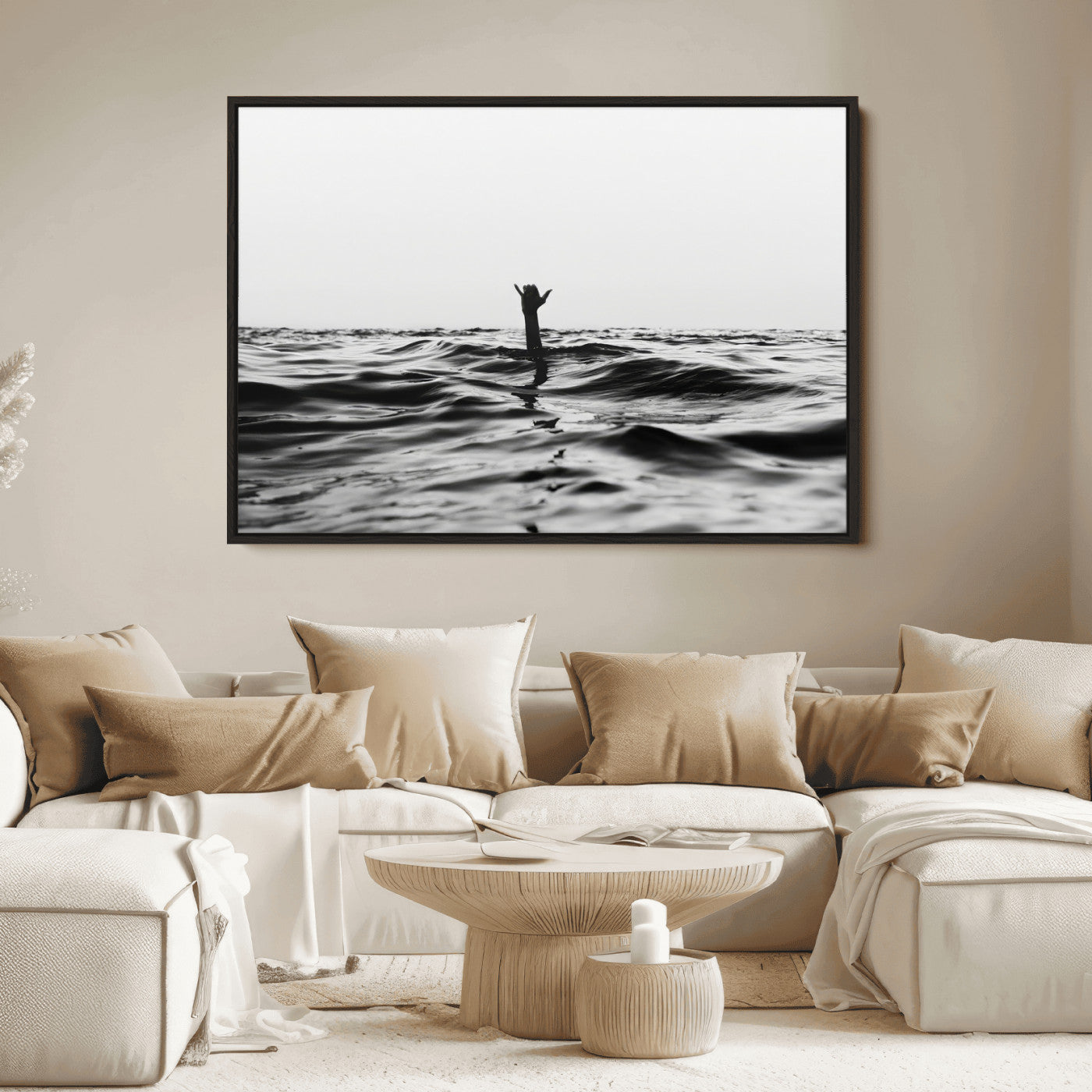 Black and white ocean with a hand making a surfer sign among dark waves, creating a dramatic and minimalist seascape with bold contrast.