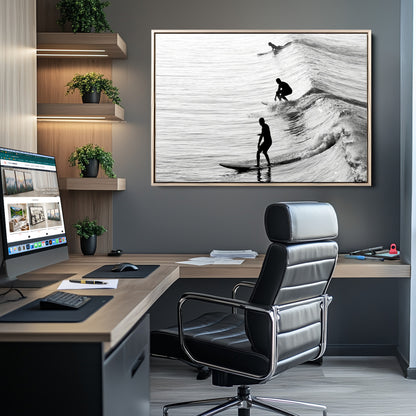 Black and white photo of surfers riding waves in a moody, high-contrast scene, ideal for modern coastal or surf-inspired home decor.