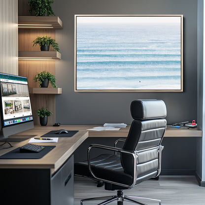 Minimalist ocean view with soft blue waves and a lone surfer, creating a serene and airy coastal aesthetic, perfect for tranquil home decor.