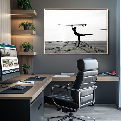 A woman balances a surfboard on her head while striking a yoga pose on the beach, silhouetted against a calm ocean horizon.